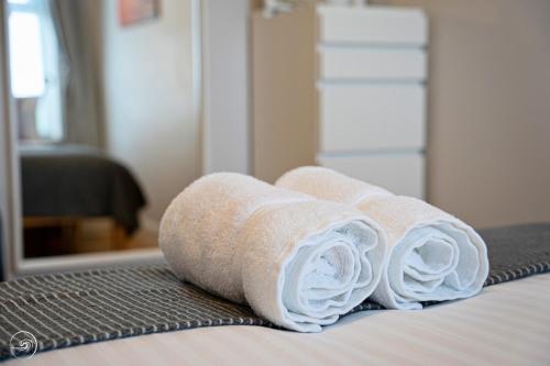 a group of towels sitting on top of a bed at Portrush by the Sea - 2 Dunluce Green in Portrush