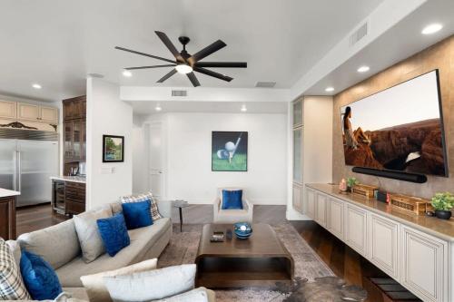 a living room with a couch and a ceiling fan at Golf Sim & Putting Green - Rooftop with 360 Views in Scottsdale