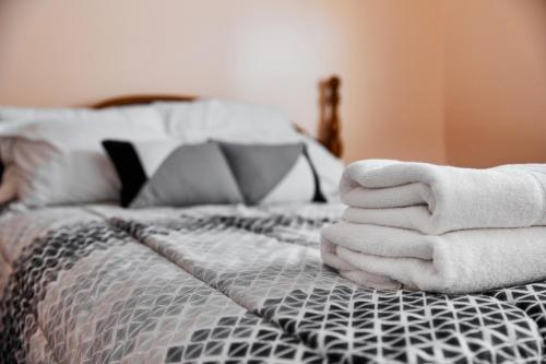 a pile of towels sitting on top of a bed at Flamingo Villa @ The Reef in Chincoteague