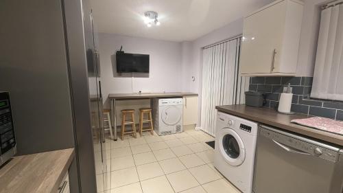 a kitchen with a washer and dryer in it at 3 bedroom detached by the sea in Prestatyn