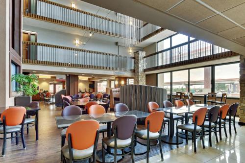 a restaurant with tables and chairs in a building at Drury Plaza Hotel San Antonio Airport in San Antonio