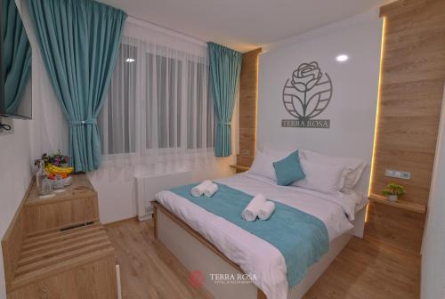 a bedroom with a bed with hello kitty pillows on it at Хотел Терра Роза in Karlovo