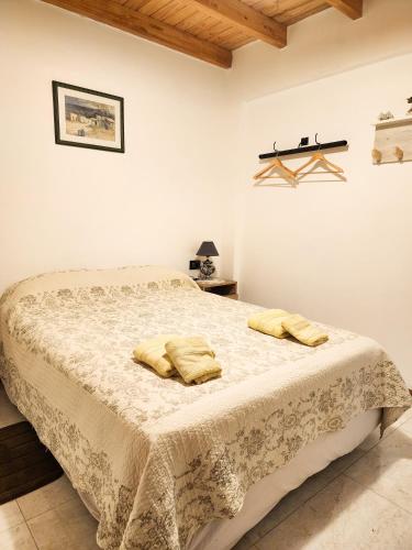 a bedroom with a bed with two yellow pillows on it at Departamento DORREGO, A estrenar in Guaymallen