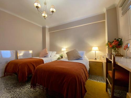 a hotel room with two beds in a room at Habitación My Home Alicante in Alicante
