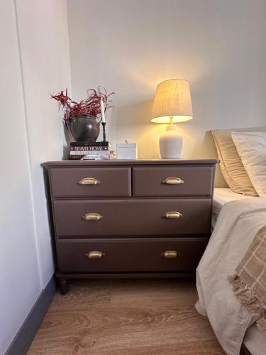 a bedroom with a dresser with a lamp on it at Pézenas Centre - Charme village - Plage 15 mn in Pézenas
