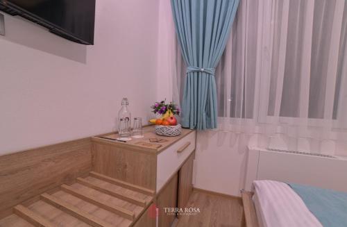 a room with a table with fruit and a window at Хотел Терра Роза in Karlovo