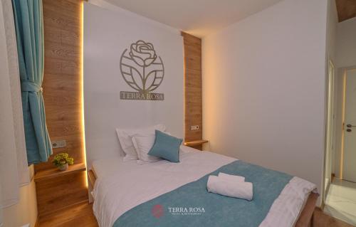 a bedroom with a bed with two pillows on it at Хотел Терра Роза in Karlovo