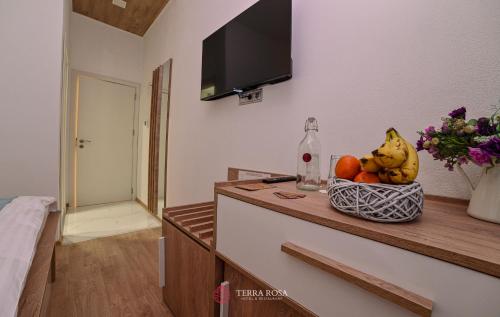 a room with a bowl of fruit on a counter at Хотел Терра Роза in Karlovo