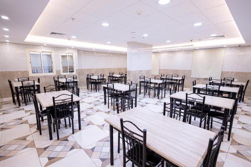an empty banquet hall with tables and chairs at Makkah Jewel Hotel in Makkah