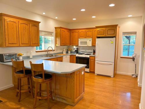 a kitchen with wooden cabinets and a white refrigerator at Country House in Alpine