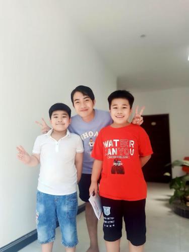 a group of three men standing next to each other at Konklor Hotel in Kon Tum