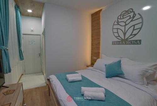 a bedroom with a bed with two pillows on it at Хотел Терра Роза in Karlovo