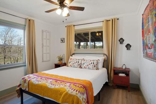 a bedroom with a bed and a ceiling fan at A Family Farmhouse in the Oak Groves of SMTX in San Marcos