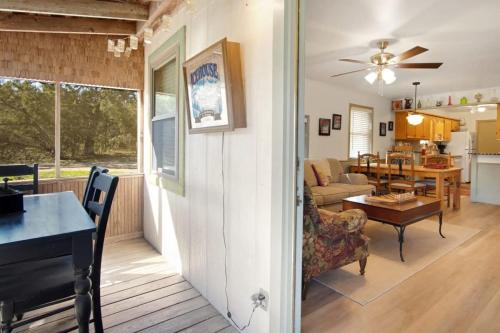 a living room and dining room with a ceiling fan at A Family Farmhouse in the Oak Groves of SMTX in San Marcos