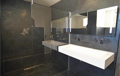 a bathroom with a white sink and a mirror at Pet Friendly Home In Trets With Heated Swimming Pool in Trets