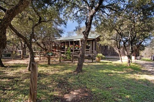 a house in the middle of a field with trees at A Rustic Romantic Getaway in Texas Hill Country in San Marcos