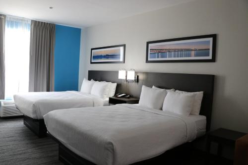 a hotel room with two beds and a window at Quality Inn & Suites in Buda