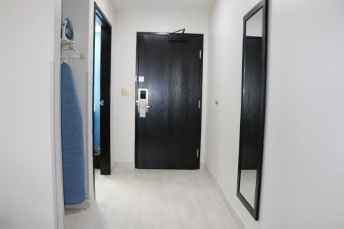 a black door in a room with a mirror at Quality Inn & Suites in Buda