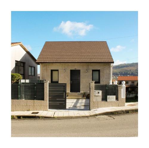 a small house with a fence in front of it at Villa Emérita in Vigo