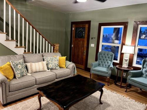a living room with a couch and two chairs at The Vintage Daisy in Pocatello