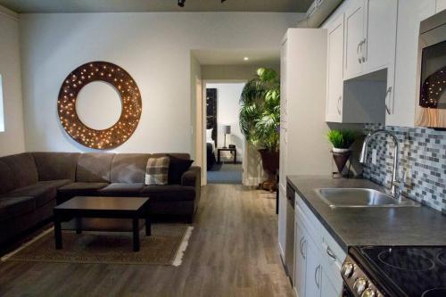 a kitchen and living room with a couch and a table at Woodbine Warehouse Apartment in Toronto