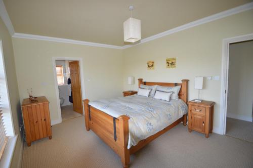 a bedroom with a large bed and a bathroom at Tighe Carra in Ballygarries