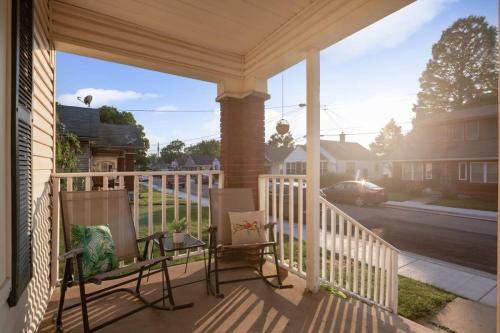 a porch with two chairs and a view of a street at Charming 2BR Getaway in New Albany