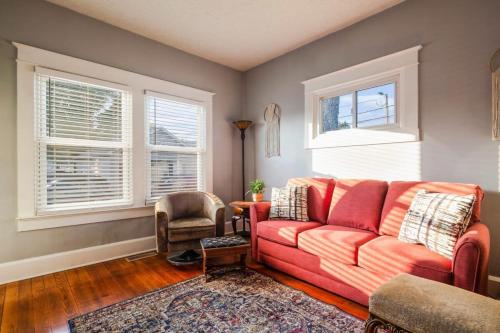 a living room with a red couch and a chair at Charming 2BR Getaway in New Albany