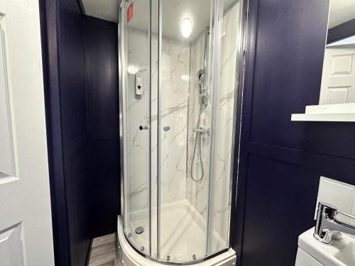 a glass shower in a bathroom with a toilet at Premier Nottingham Studios - Gawthorne in Nottingham