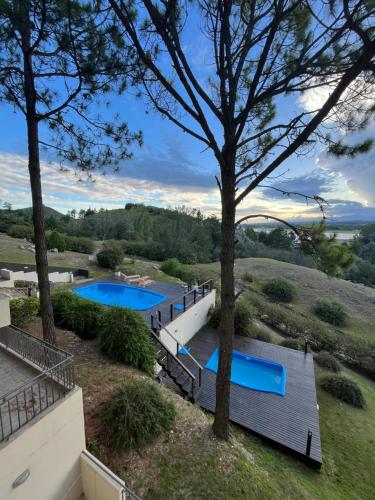 an aerial view of two swimming pools in a yard at Condominio Monte Molinos - La Vista in Villa Ciudad de America