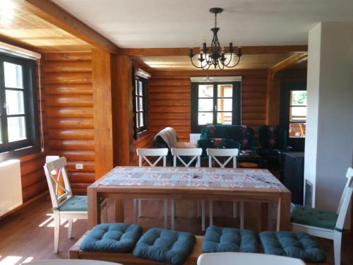 a living room with a table and chairs at Family friendly house with a parking space Otocac, Velebit - 20654 in Otočac