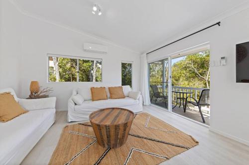 a living room with a couch and a table at (HA2)BEACH VIBES Sunshine beach,100m to Beach, in Sunshine Beach
