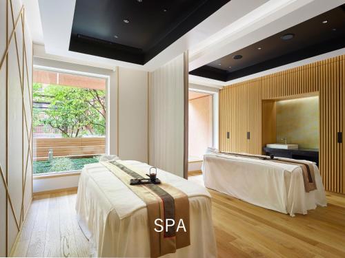 a spa room with two beds and a window at Hotel The Celestine Tokyo Shiba in Tokyo