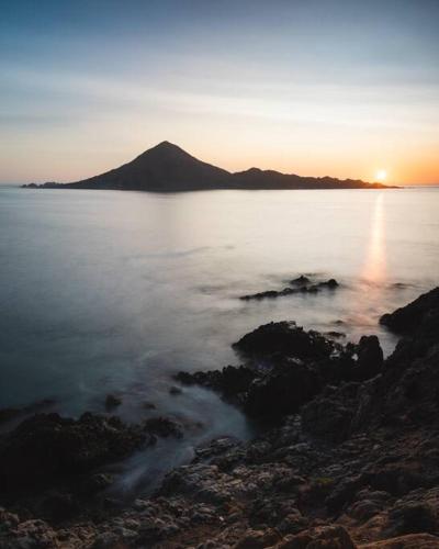 a sunset over a large body of water at Cabaña el Mirador Caleuche. in Ciudad de Chañaral