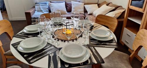 a dining room table with glasses and plates on it at Baireshistorico in Buenos Aires