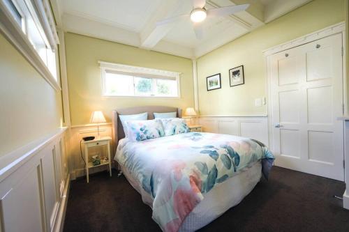 a bedroom with a bed and a window at By the Beach Coastal Cabin with Hot Tub in Cowes