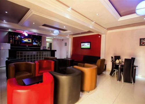 eine Bar mit Stühlen und einem Tisch in einem Zimmer in der Unterkunft De Rigg Place - Alaka Estate, Surulere in Lagos