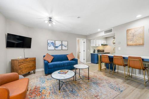 a living room with a blue couch and a table at Modern Urban Oasis in Prime Buckhead Atlanta in Atlanta