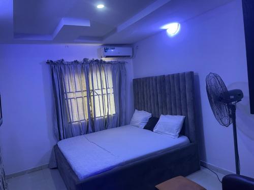 a small bedroom with a bed and a window at Nobles Hotel & Suites in Lagos