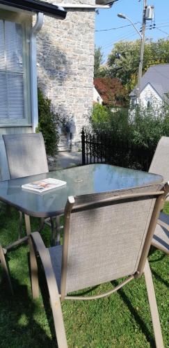 a picnic table and chairs in front of a house at Stone Carriage House in Picton
