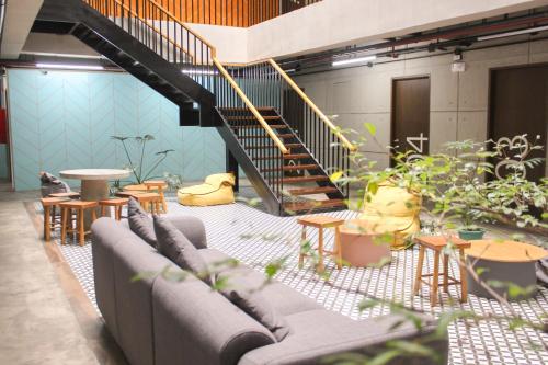 a living room with couches and tables and a staircase at 217 Bonifacio Residences in Baguio