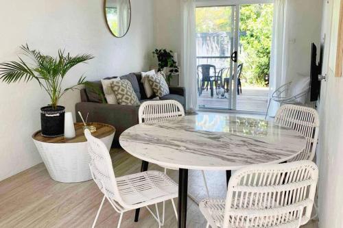 a living room with a table and chairs and a couch at PA1,Great Holiday in Sunshine Beach with your pets in Sunshine Beach