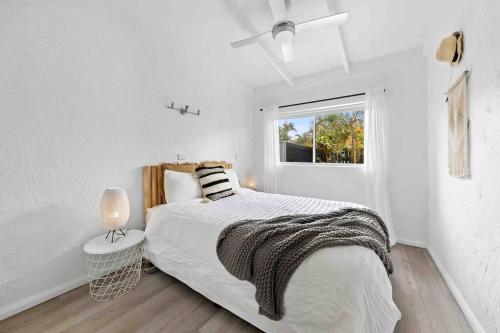a white bedroom with a bed and a window at PA1,Great Holiday in Sunshine Beach with your pets in Sunshine Beach