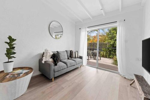 a dog sitting on a couch in a living room at PA1,Great Holiday in Sunshine Beach with your pets in Sunshine Beach