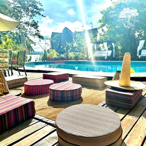 a patio with a table and chairs and a swimming pool at Casa Caoba RD in Río Dulce