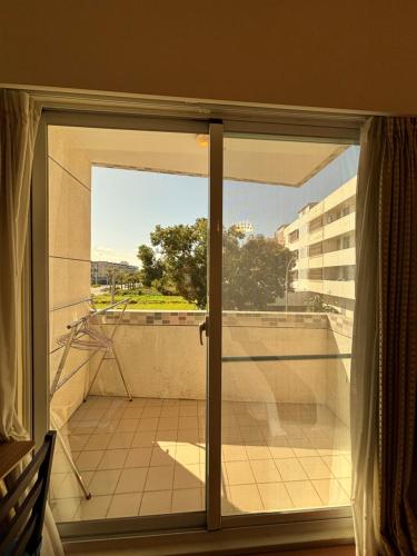 a sliding glass door to a balcony with a view at 樂活小築民宿Lohas Taitung B&B in Taitung City