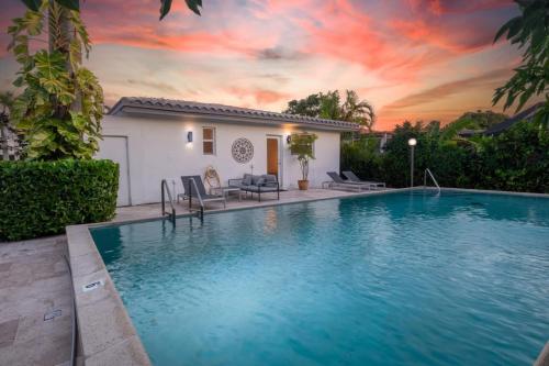 a swimming pool in front of a house at Perfect Beach Home For A Family Getaway Wpool! in Miami Beach