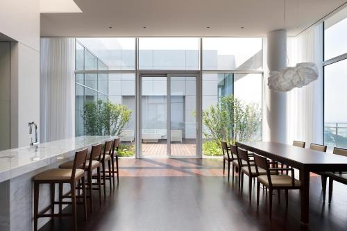 a dining room with a long table and chairs at SEAMARQ HOTEL in Gangneung