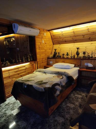 a bedroom with a large bed in a wooden room at Mousa's studio in Jerash