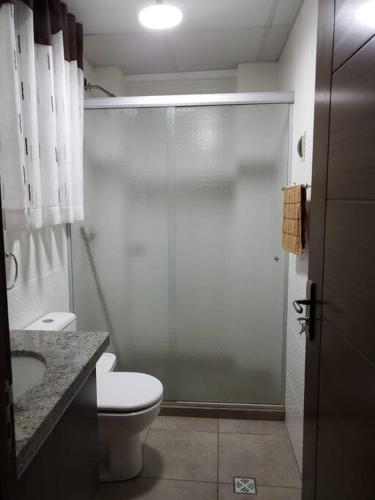 a bathroom with a shower and a toilet and a sink at Apartamentos La Floresta in Cochabamba